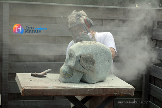 Ivo Manus sculpting a large crystal skull, showcasing the scale of the Monumental creation.